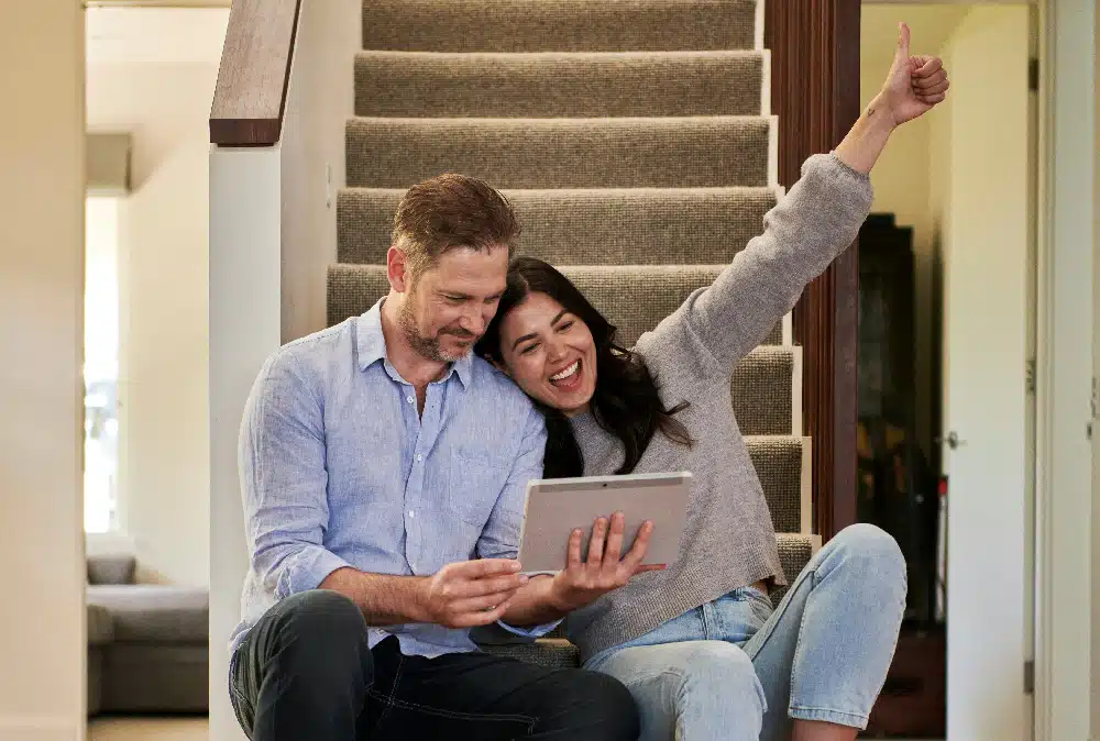 Couple reviewing loan information on a tablet at home.